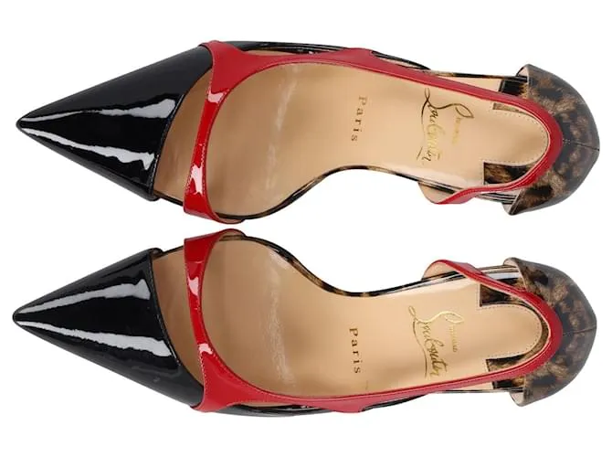 Tacones puntiagudos con ribete rojo de Christian Louboutin en charol con estampado animal 
